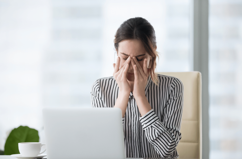 A woman rubbing her dry eyes