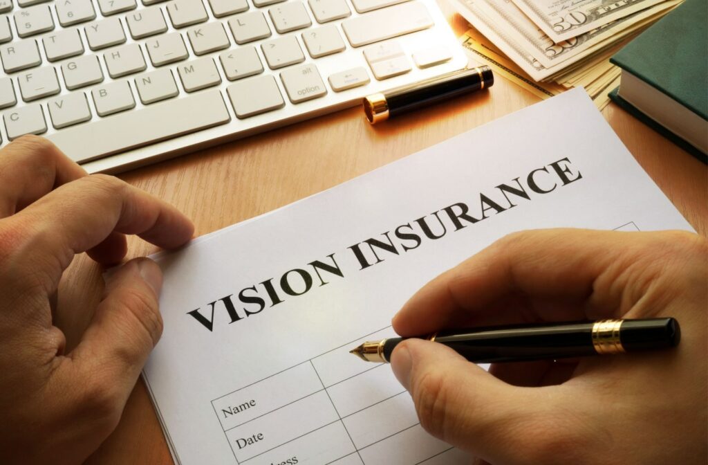 A man filling out an application for vision insurance