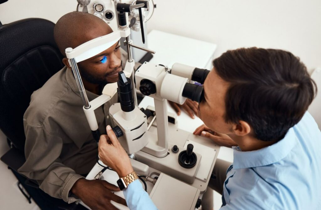 Patient at an eye exam with optometrist, testing eyesight.