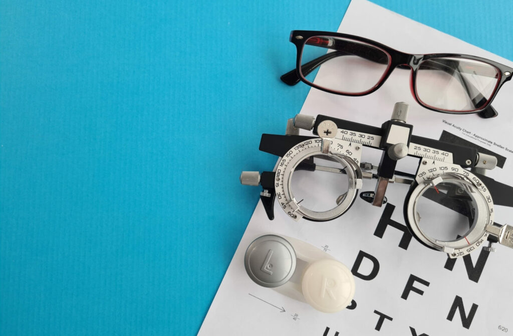 Collection of glasses with vision chart and contact lens case.