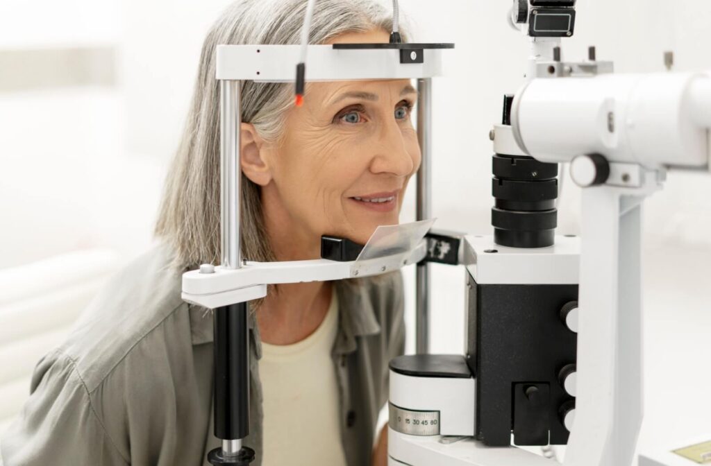 An older adult with minimal makeup undergoes a comprehensive eye examination.